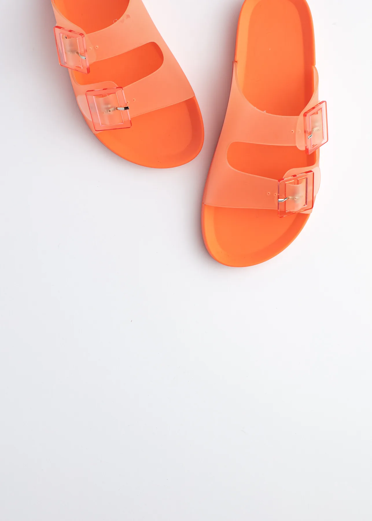 Bright orange poolside slides on a clean white background